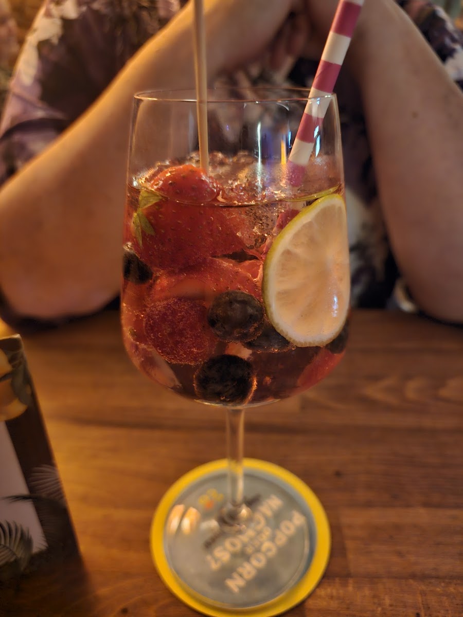 Cocktail mit Erdbeeren und Blaubeeren am Außentisch